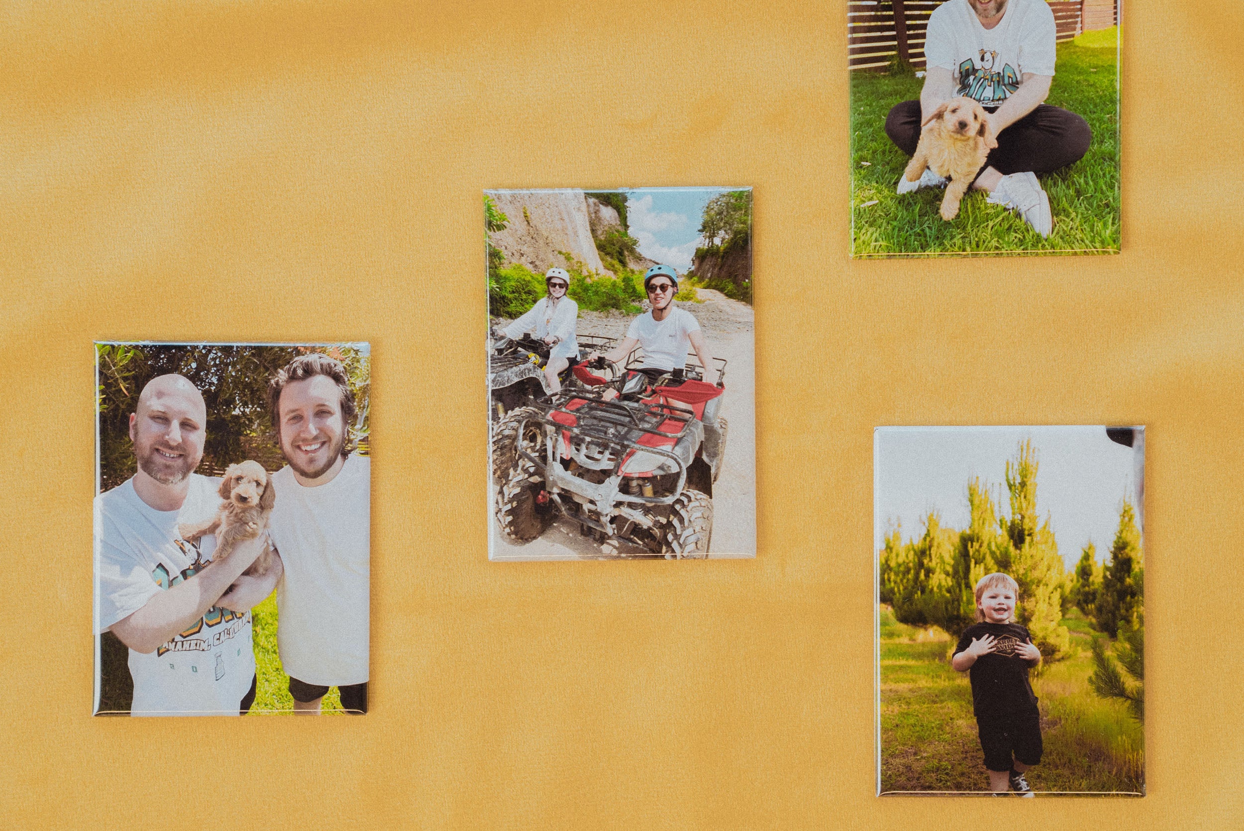 Various magnets with custom prints displayed on a yellow background.