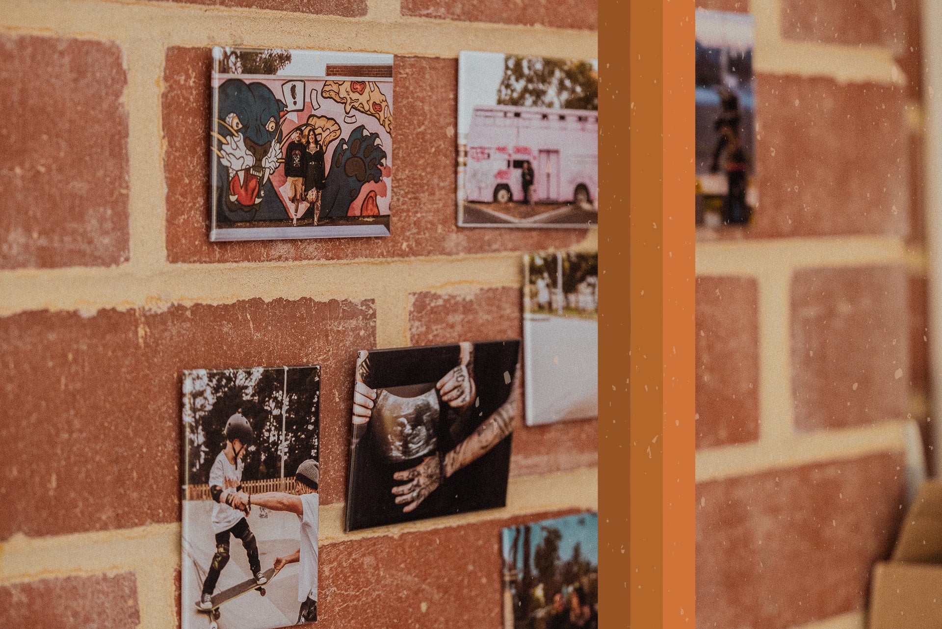 Various customised magnets displayed on a brick wall.