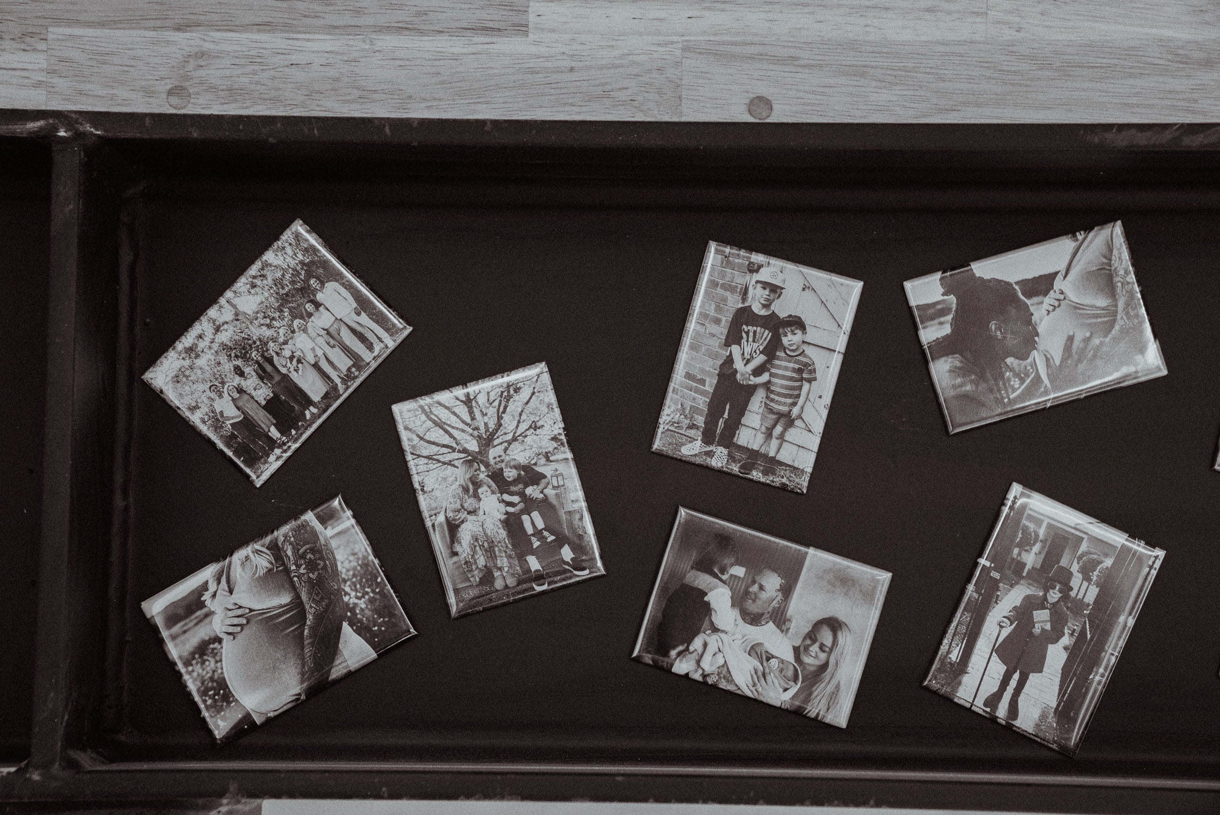 Various magnets with custom prints displayed in black and white.