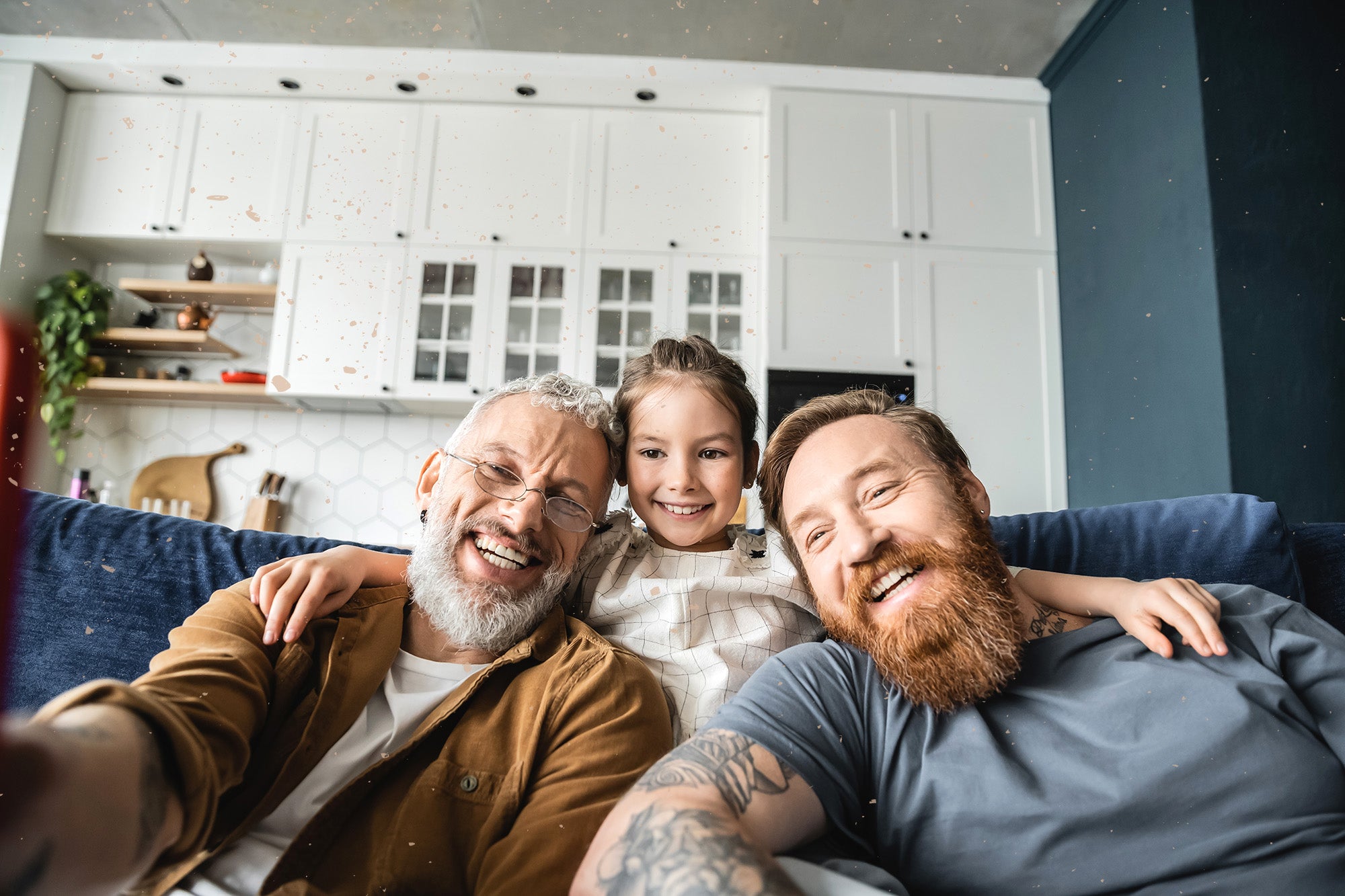 A magnet with a family photo of an older man, a younger man, and a child.