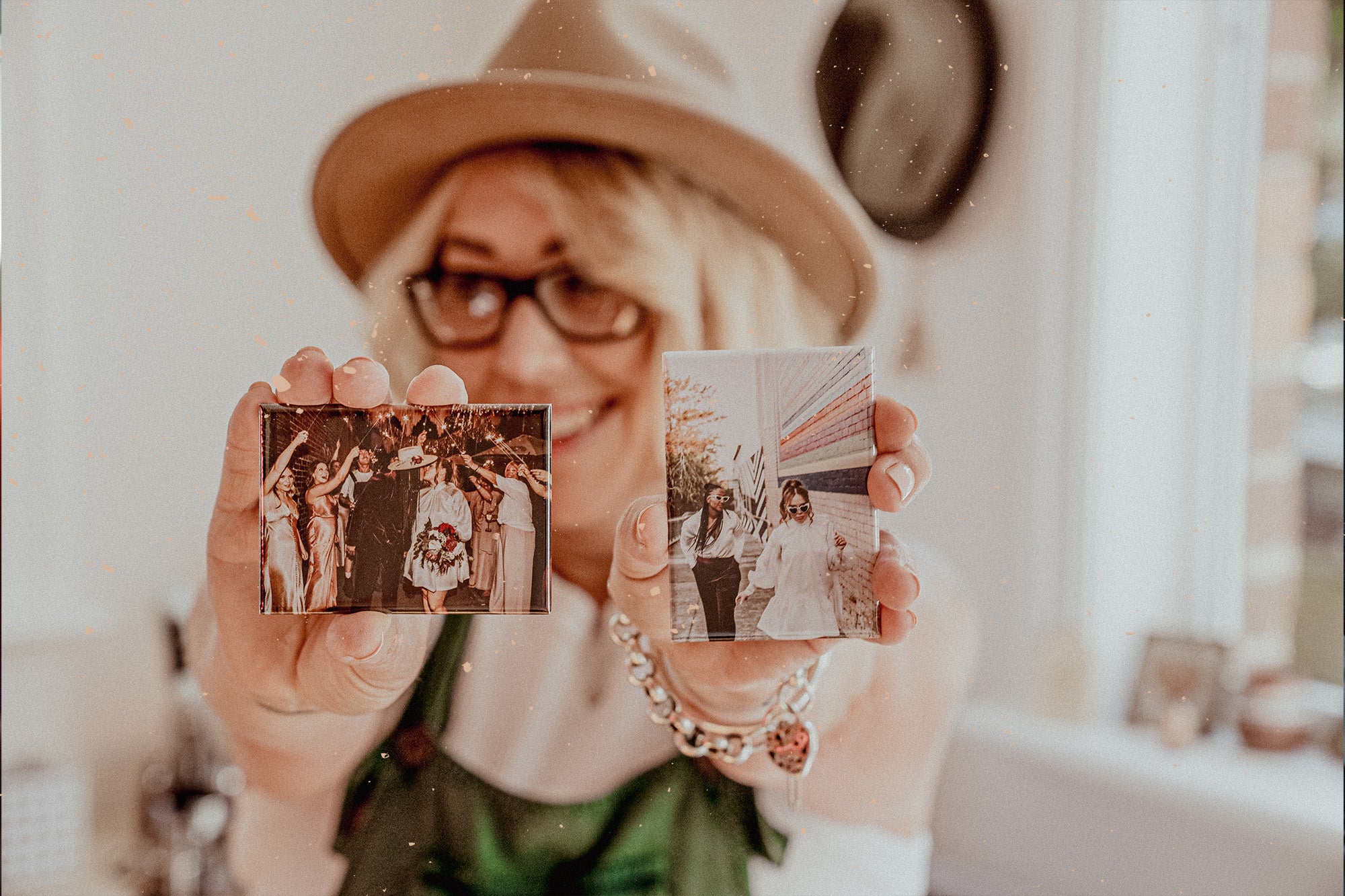 Founder of Urban Magnet Co, Mel, holding up two customised magnets printed with wedding photos.